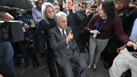 Getty Images Lenin Moreno leaves the National Court of Justice during a corruption case in Quito.