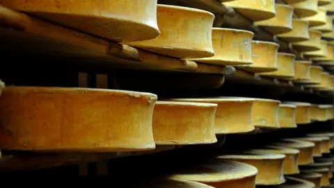 AFP via Getty Images Beaufort cheese wheels stored in a cellar in eastern France. Archive photo