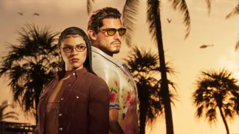 Rockstar Games A screenshot from GTA 6 shows main characters Lucia and Jason standing back-to-back against a palm tree-lined sunset. She wears tinted glasses, her long dark hair styled in side-parted cornrows. She wears a tan suede jacket over a string bikini top. He also wears tinted shades and a white shirt with an oversized collar and floral pattern.