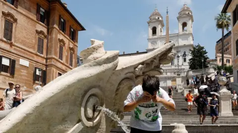 Reuters A boy cools off at the Barcaccia fountain near the Spanish steps during a heatwave, as temperatures are expected to rise further in the coming days, in Rome, Italy August 3, 2026.