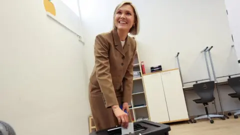 Reuters Iceland's Prime Minister Kristrun Frostadottir votes in the national referendum on resuming EU membership talks, at a polling station in Reykjavik