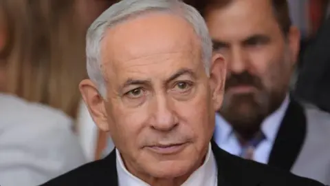 EPA/Shutterstock Close up of Benjamin Netanyahu from the shoulders up. He has short, grey hair and is wearing a shirt, tie and suit.