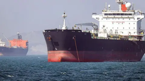 Getty Images In this picture obtained from Iran's ISNA news agency and taken on May 2, 2026, the Gambia-flagged tanker vessel Bili is pictured anchored in the Strait of Hormuz off Bandar Abbas in southern Iran.