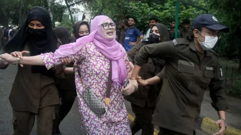EPA A protester is detained as others gather in support of the banned Joint Awami Action Committee (JAAC), an alliance of Kashmir's civil society groups, during a demonstration in Lahore, Pakistan, 31 July 2026