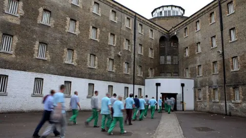 Andrew Aitchison/In Pictures Ltd./Corbis via Getty Images Unidentified prisoners return from their jobs to their wings for lunch at Wandsworth prison
