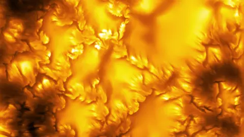 NSF/NSO/AURA/MPS The image shows an extreme close-up of the surface of the Sun, captured by the world's most powerful solar telescope. It shows a fiery orange glow with patterns that look almost like etchings of leaves across the surface. These patterns are evidence of "swirls of instability" on the Sun's surface.