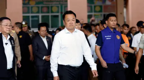 EPA Thai Prime Minister Anutin Charnvirakul (C) and Minister of Education Prasert Jantararuangtong (L) arrive to inspect the site following a school shooting at Debsirin Nonthaburi School