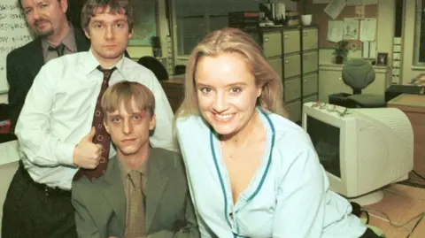 BBC Picture shows (from back) Ricky Gervais as David Brent, Martin Freeman as Tim, MacKenzie Crook as Gareth and Lucy Davis as Dawn in the office
