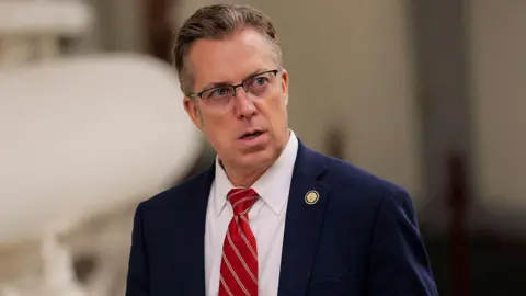 Getty Images Republican Andy Ogles in a suit and red tie 