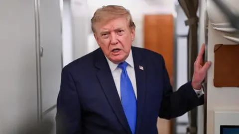 Reuters US President Donald Trump speaks to the media aboard Air Force One en route to Joint Base Andrews.