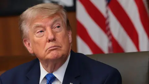 Getty Images President Donald Trump listens to questions from reporters during a Cabinet meeting at Camp David, the presidential retreat, on July 31, 2026 in Camp David, Maryland. 