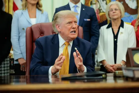 Getty Images US President Donald Trump speaks to the media after signing an executive order establishing the President's Military Spouse Commission in the Oval Office at the White House on August 03, 2026 in Washington, DC. 