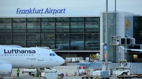 Getty Images A view of a taxiing area at Frankfurt Airport. A Lufthansa plane sits on the tarmac. 
