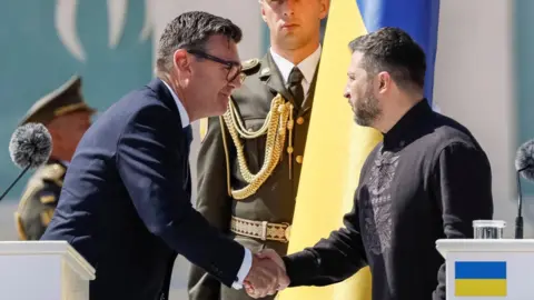 Reuters Britain's Prime Minister Andy Burnham greets Ukrainian President Volodymyr Zelenskiy