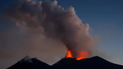 Reuters Drone footage shows lava being ejected from a crater during an eruption of Mount Etna at dusk, in Sicily, Italy, on 13 August 2026.