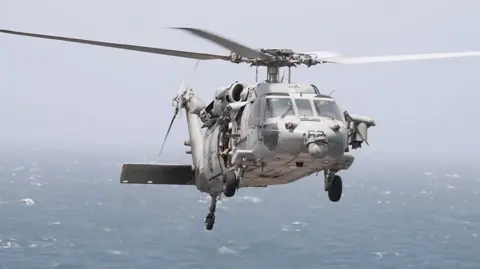 US Central Command A photo of a US Navy MH-60 helicopter used by US Central Command in its post to inform about missile strikes on a cargo ship