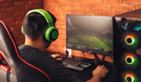 Getty Images Young man sits with his back to the camera playing eSports on a PC 