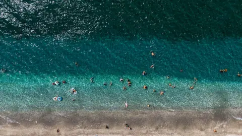 Getty Images Aerial view of strip of beach in Greece and ocean