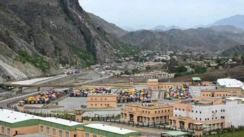 AFP Afghan refugee trucks are parked along the Landi Kotal highway near the Torkham border in Pakistan's Khyber Pakhtunkhwa province, as they await deportation to Afghanistan on April 28, 2026