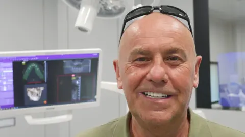 BBC Anthony Hook smiles to show off his new teeth