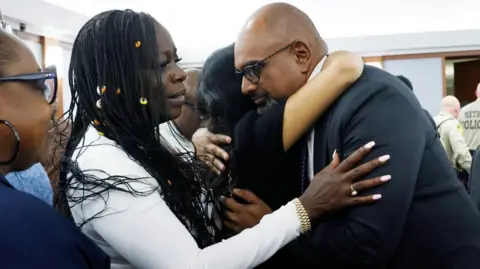 Reuters Friends and family members of rapper Tupac Shakur, including his sister Sekyiwa Shakur, line up to hug Chief Deputy District Attorney Binu Palal