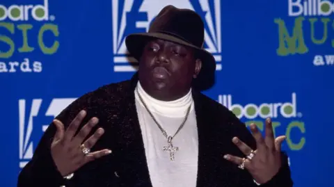 Getty Images Rapper Notorious B.I.G. AKA Biggie Smalls (Christopher Wallace) receives Billboard Music Award on December 6, 1995 at The Coliseum in New York City, 