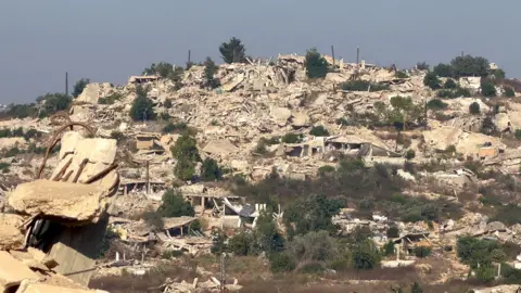 Neha Sharma/BBC Destroyed buildings on a hilltop where a village once stood in southern Lebanon
