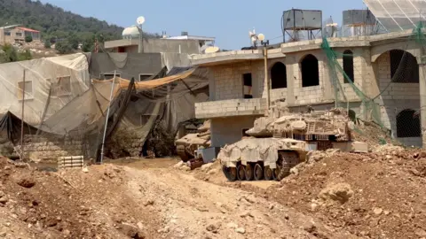 Neha Sharma/BBC Nets are seen hanging above buildings used by the Israeli military in southern Lebanon