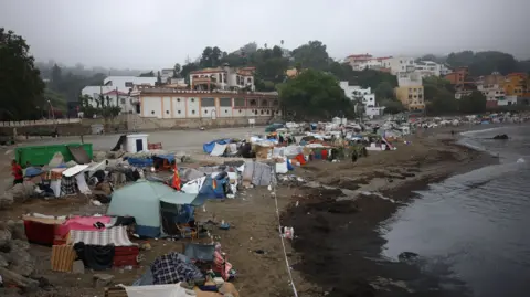 Reuters Tents along the Trampolin Beach in Ceuta on a cloudy day.