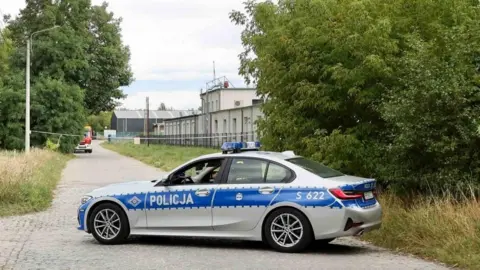 EPA Police investigate the cause of a fire at the WB Group plant in Skarzysko-Kamienna, Poland, 31 August 2026