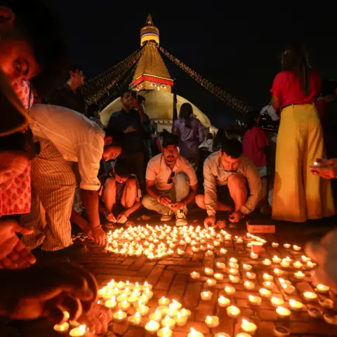 NurPhoto via Getty Images Candlelight vigil for flood victims held in Kathmandu on 3 September