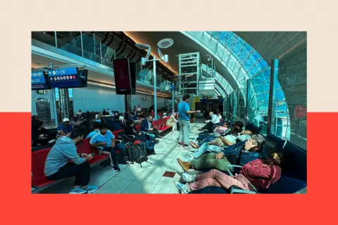 AFP via Getty Images An airport terminal full of people waiting