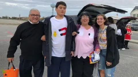 Linda Mancuso Michael Mancuso, is 23, 5'10 and 200-plus pounds, towering over his parents as he stands arm-in-arm with them at a Halloween event under an overcast sky