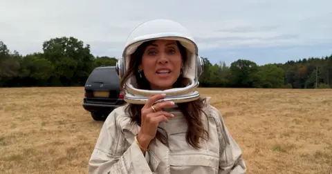 Natalie Imbruglia / Landgirl Natalie Imbruglia wears an astronaut's helmet in the video for her single Beautiful Love