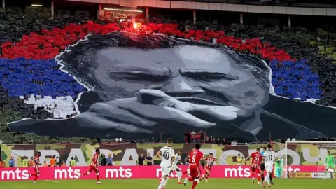 Getty Images Red Star Belgrade supporters form a tifo depicting the late former Bosnian Serb military chief Ratko Mladic during the Serbian SuperLiga football match between Red Star Belgrade and Partizan Belgrade in Belgrade, Serbia, on September 6, 2026. 