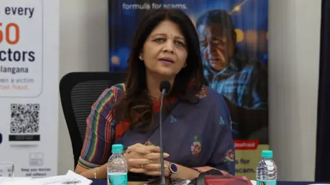 Shikha Goel Shikha Goel, a cyber police officer from India's Telangana state, speaks into a mic while sitting at a desk