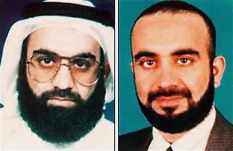 FBI This is a composite FBI image containing two undated images side by side of  Khalid Sheikh Mohammed. On the left he has a big black beard, a headscarf and glasses. On the right he has a bare head with dark hair and a dark beard, wearing a suit.