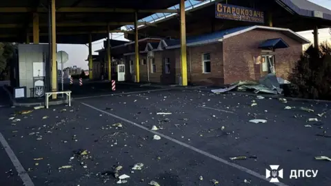 Reuters A deserted border checkpoint Starokozache sits behind a road strewn with debris.