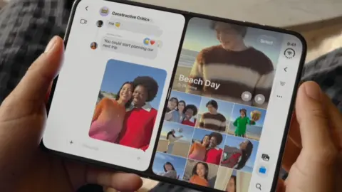 Apple/courtesy Hands holding the folding iPhone like a book, with messages on one side and images on the other.
