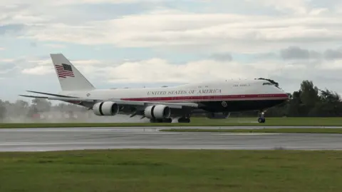 PA Media Red, blue and white plane landing on tarmac