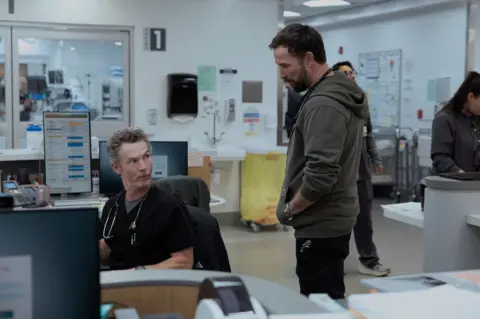 Warner Brothers Picture of Wyle speaking with a member of medical staff