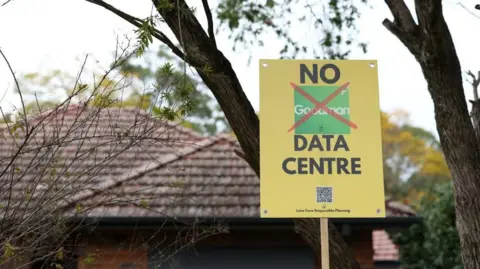Reuters A yellow placard reading 'No data centre' in front of a house and trees
