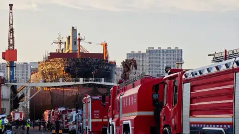 Xinhua Emergency vehicles seen on the road to the docked ship