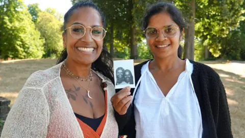 Reuters Indian-born women Meena Geltink, 43, and Minal Tijssen, 44, adopted separately as babies and raised near each other in the Netherlands, meet after a DNA test revealed they were biological sisters, in 's-Hertogenbosch, Netherlands, August 11, 2026. REUTERS/Marta Fiorin