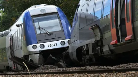 AFP via Getty Images A derailed carriage of a passenger train in Cléon, northern France. Photo: 12 September 2026.