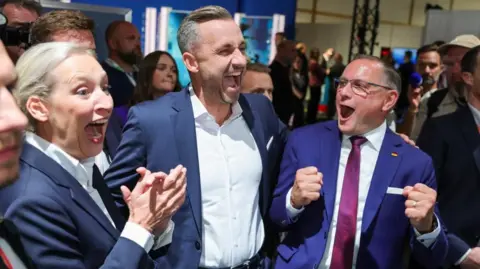 Reuters Top candidate of the far-right Alternative for Germany (AfD), Ulrich Siegmund, with party co leaders Alice Weidel and Tino Chrupalla, reacts after polls closed, on the day of the Saxony-Anhalt state elections