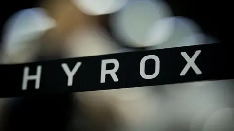 Getty Images A stock image with a banner showing the name Hyrox over an out-of-focus background.