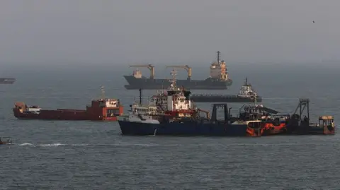 Getty Images File photo showing commercial ships anchored in the Strait of Hormuz, off the coast of Bandar Abbas, Iran (10 August 2026)