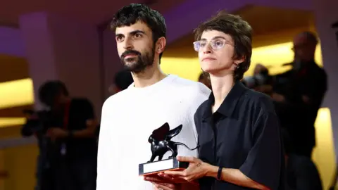 Reuters Directors Yuval Abraham and Rachel Szor hold the Special Jury Award for their documentary film, Naza, during the closing ceremony of the 83rd Venice International Film Festival, Italy (12 September 2026)