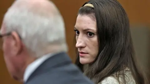Reuters Lindsay Clancy in court next to her lawyer